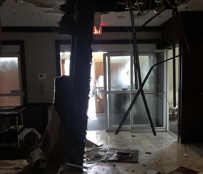 Water damage has caused a ceiling to collapse in the hallway of a hotel.