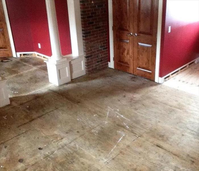 Restoring a multi-family home, the floors have been removed and the walls are freshly painted.