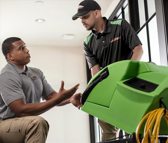 SERVPRO technicians move equipment for drying.