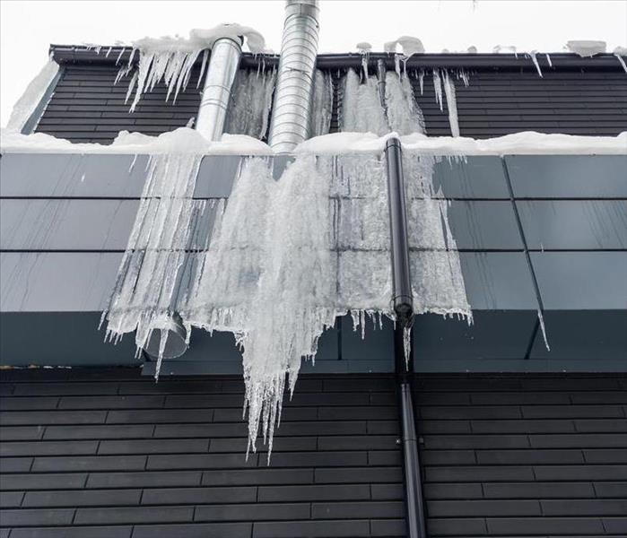 Icicles are hanging from a building.